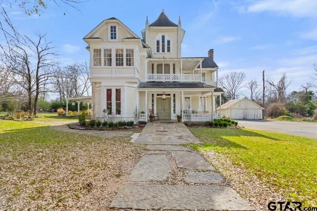 a front view of a house with yard and green space