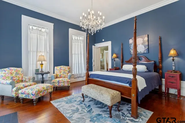 a view of a livingroom with furniture wooden floor and a chandelier