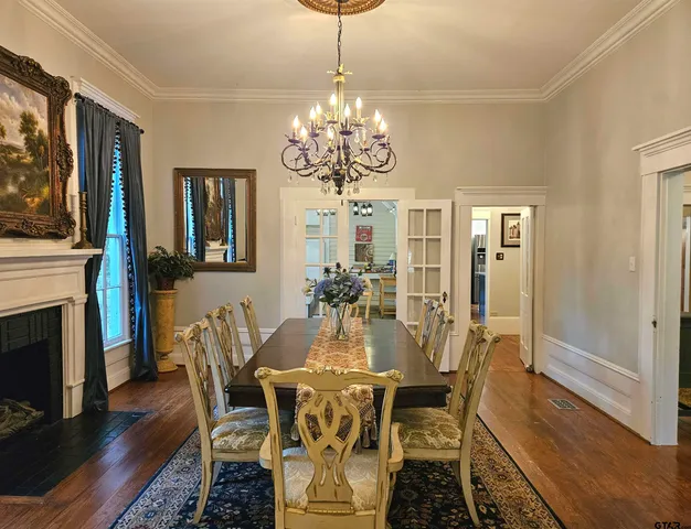 a view of a dining room with furniture wooden floor and chandelier