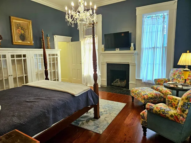 a bedroom with a bed and a fireplace