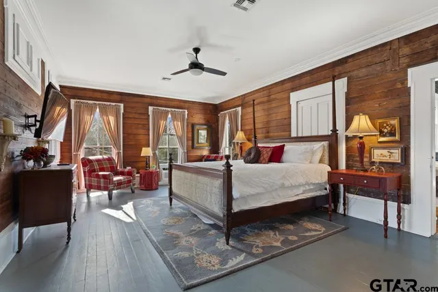 a living room with furniture a wooden floor and next to a window
