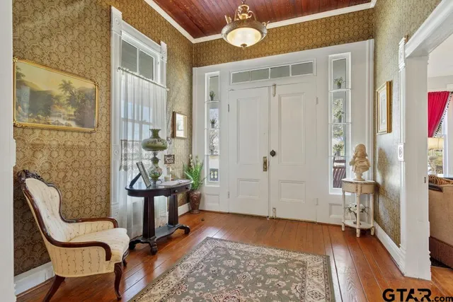 a view of a livingroom with furniture and hardwood floor