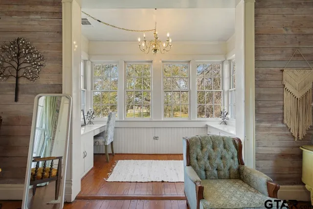 a spacious bedroom with a bed and a flat screen tv