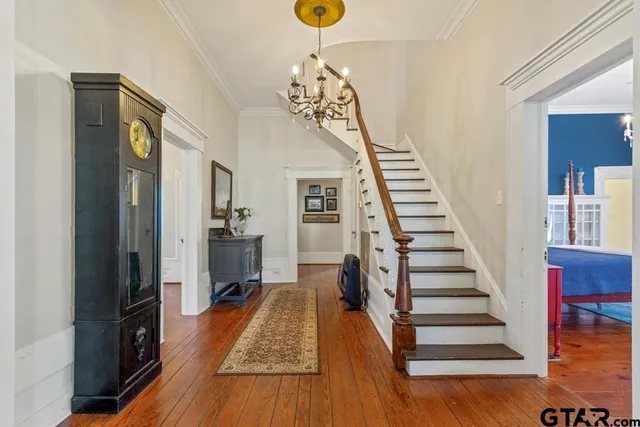 a view of entryway and hall with wooden floor