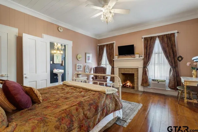a hallway with white cabinets and wooden floor
