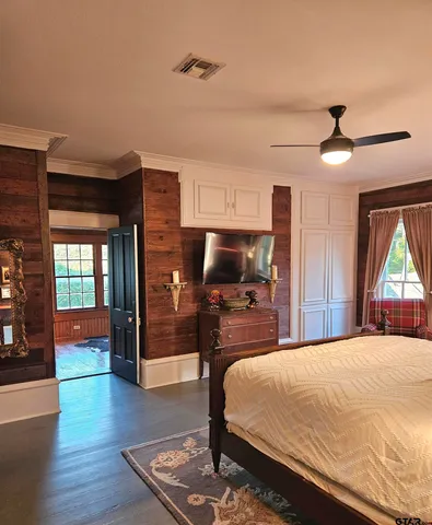 a bed room with a bed mirror and a window