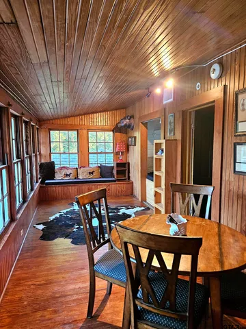 a dining room with furniture a rug and wooden floor