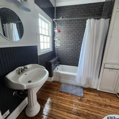 a bathroom with a sink a toilet and bathtub