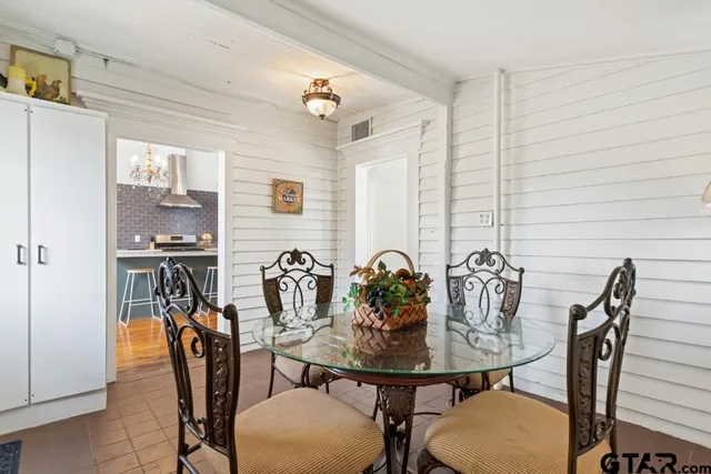 a view of a backyard with table and chairs under an umbrella