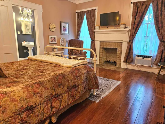 a bedroom with a bed and a fireplace