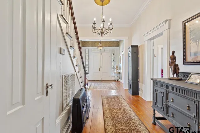 a very nice looking room with a large window and wooden floor