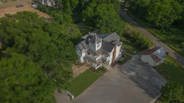 an aerial view of a house with outdoor space and street view