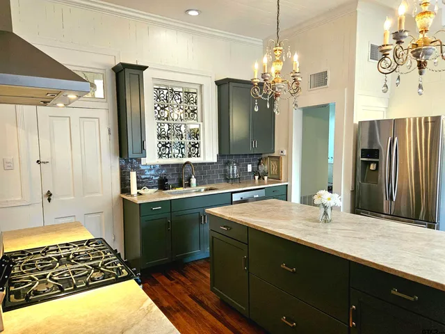 a bathroom with a granite countertop sink a large mirror and a shower