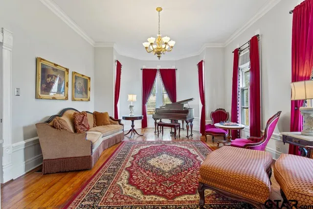 a living room with furniture a rug and a chandelier