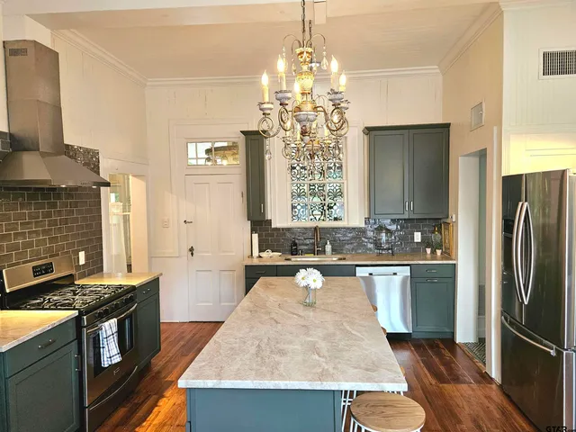 a kitchen with a sink stove and refrigerator