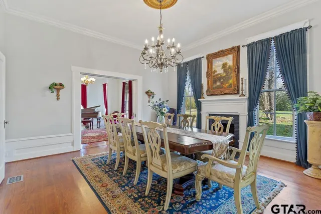 a kitchen with stainless steel appliances granite countertop a stove top oven a refrigerator a sink and dishwasher a oven with wooden floor