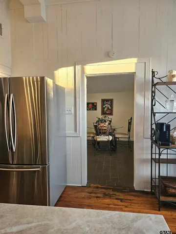 a kitchen with refrigerator and table