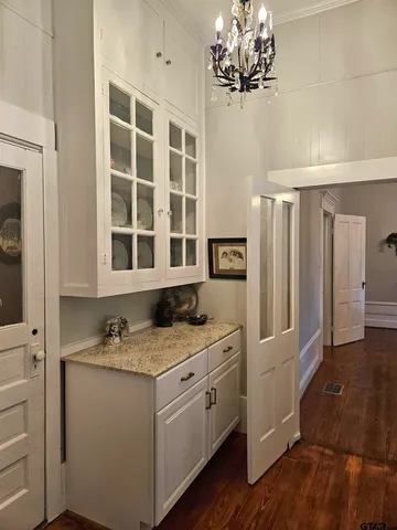 a bathroom with a granite countertop sink a mirror and a shower