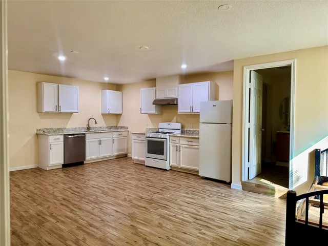 a kitchen with stainless steel appliances a sink and a refrigerator