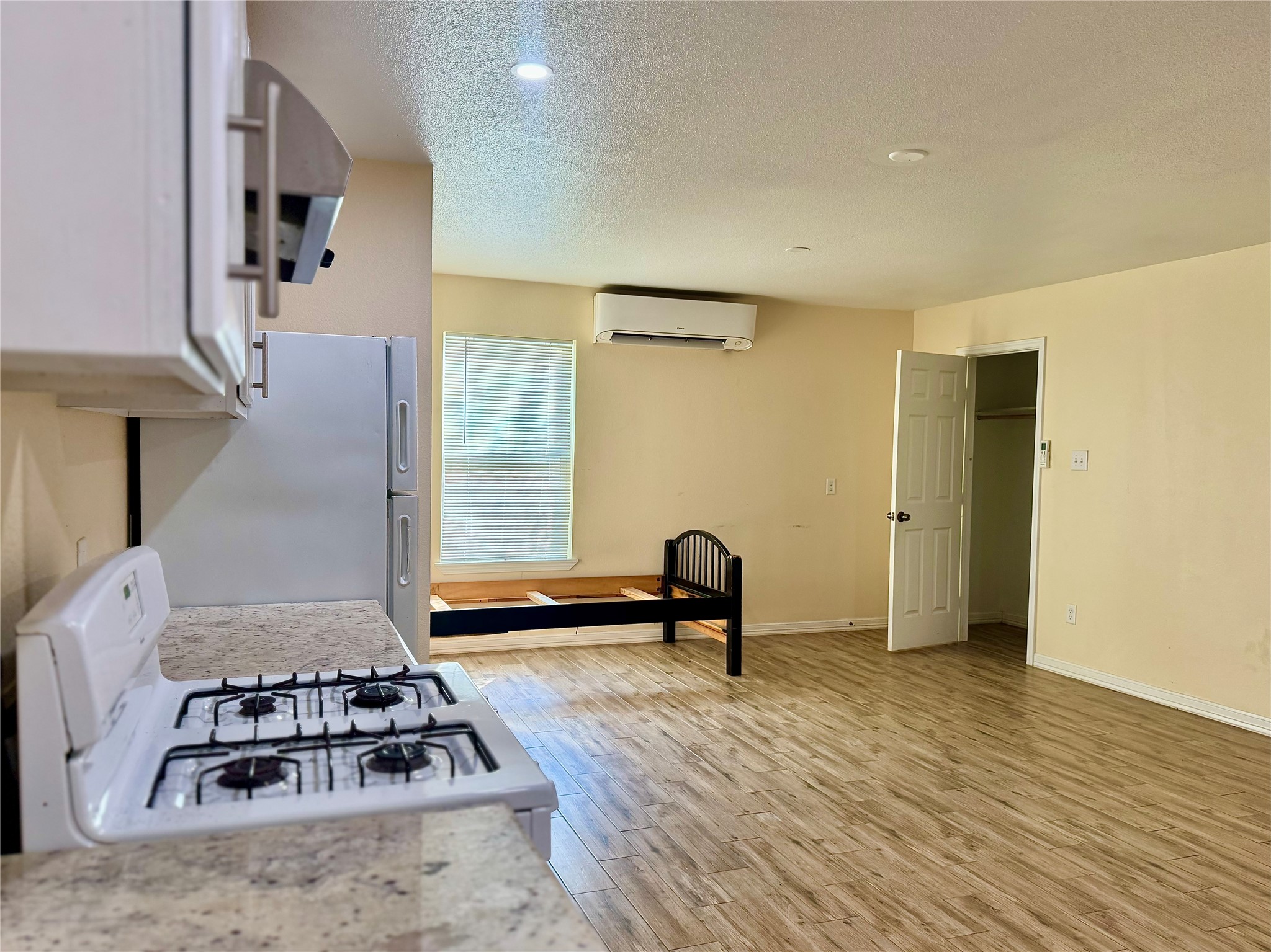 711 Hahlo Street, Unit STUDIO Houston, TX 77020 - Photo 2 of 10 a view of a room with a couch and wooden floor