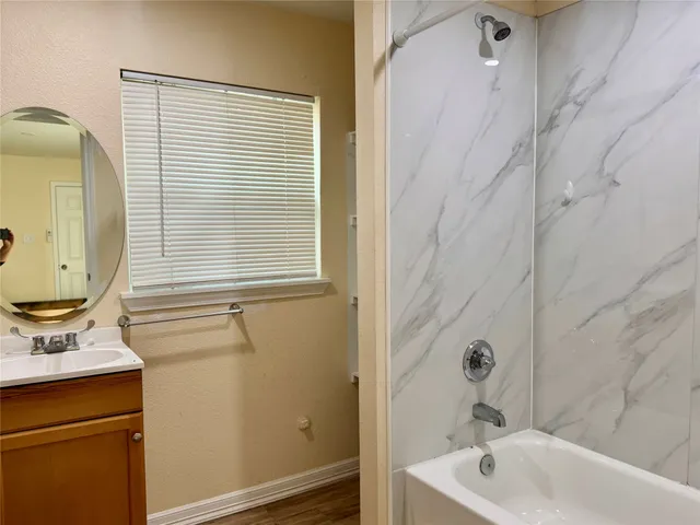 a bathroom with a sink a bathtub and a shower