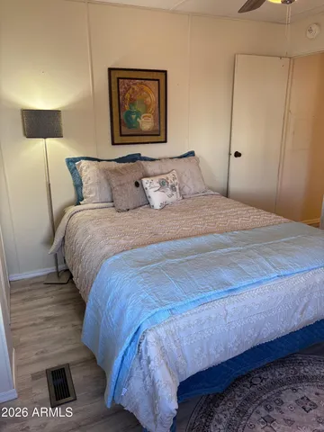 a bedroom with a bed and a night stand