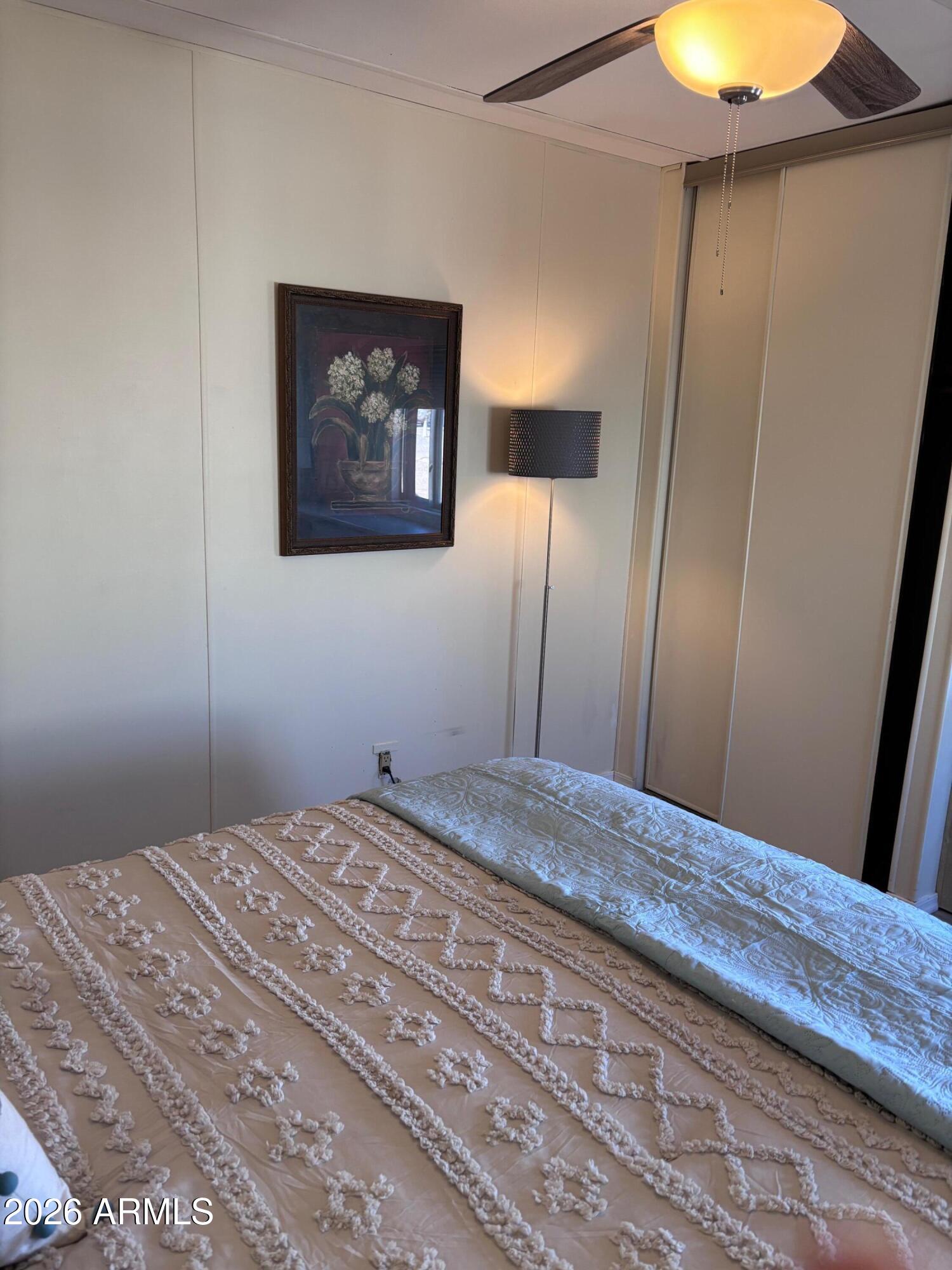 15802 South Gilbert Road, Unit 131 Chandler, AZ 85225 - Photo 13 of 30 a bedroom with a bed and a chandelier