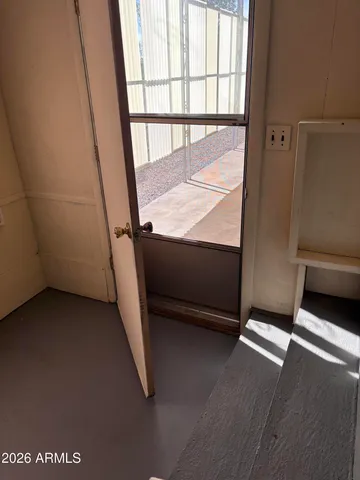 a view of a room with wooden floor