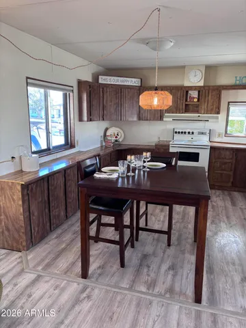 a kitchen with a table chairs and a wooden floor
