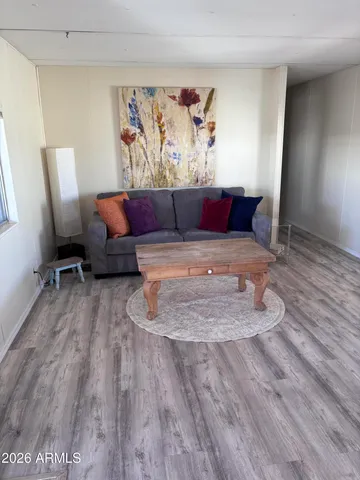 a living room with furniture and a wooden floor