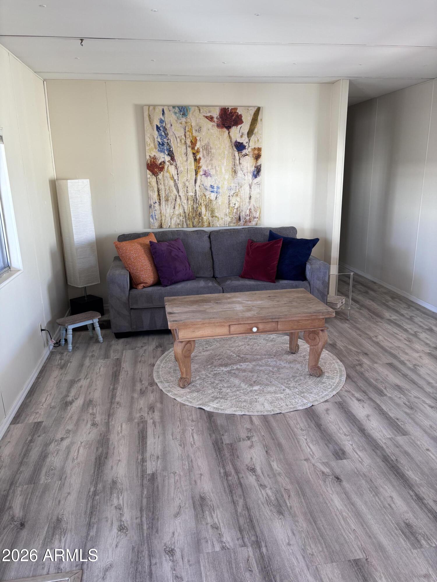 15802 South Gilbert Road, Unit 131 Chandler, AZ 85225 - Photo 8 of 30 a living room with furniture and a wooden floor