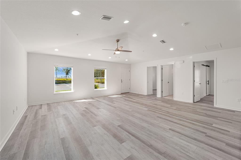 4417 Northwest 74th Terrace Ocala, FL 34482 - Photo 19 of 77 a view of an empty room with wooden floor and a window
