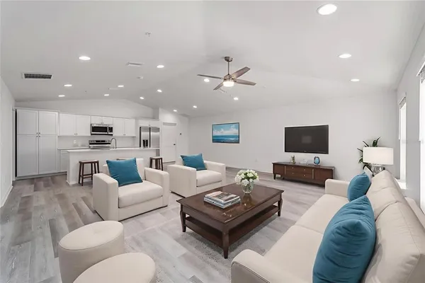 a living room with furniture kitchen view and a couch