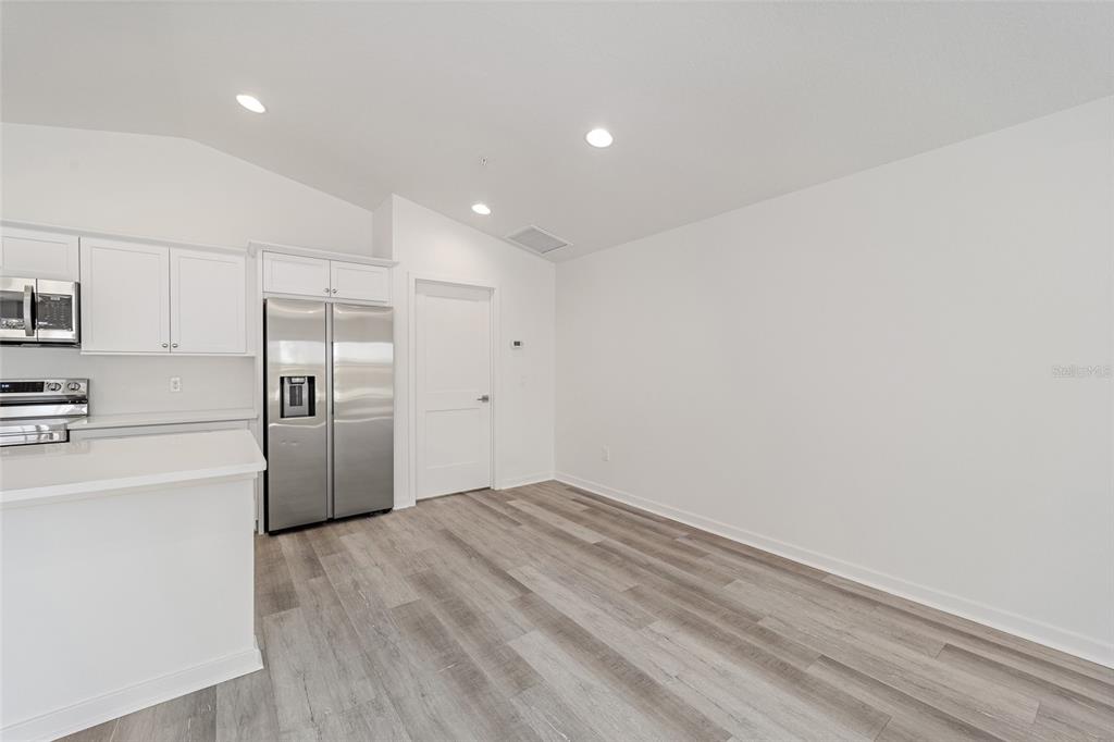 4417 Northwest 74th Terrace Ocala, FL 34482 - Photo 24 of 77 a view of a kitchen with a sink a refrigerator and a stove top oven