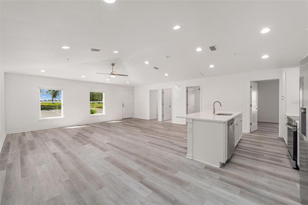 4417 Northwest 74th Terrace Ocala, FL 34482 - Photo 26 of 77 a view of a kitchen with a sink and dishwasher with wooden floor