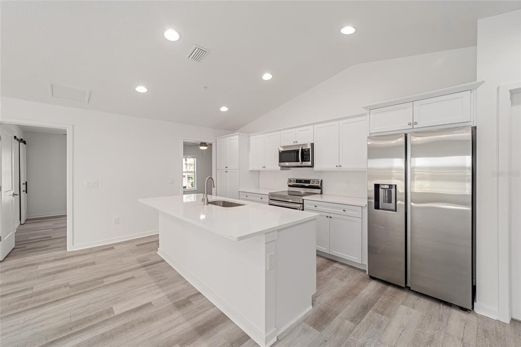 4417 Northwest 74th Terrace Ocala, FL 34482 - Photo 27 of 77 a kitchen with stainless steel appliances a refrigerator sink and stove