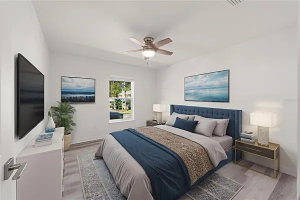 a bedroom with a large bed and a flat screen tv