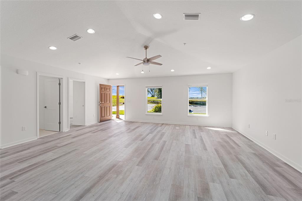 4417 Northwest 74th Terrace Ocala, FL 34482 - Photo 37 of 77 an empty room with wooden floor and windows