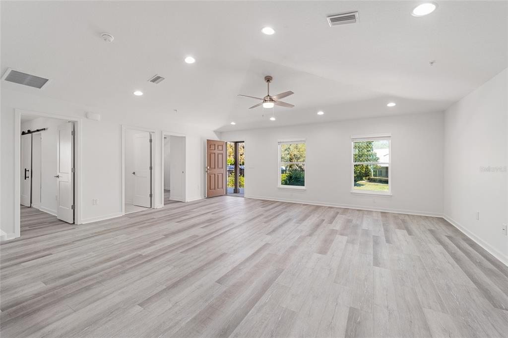4417 Northwest 74th Terrace Ocala, FL 34482 - Photo 41 of 77 an empty room with wooden floor and windows