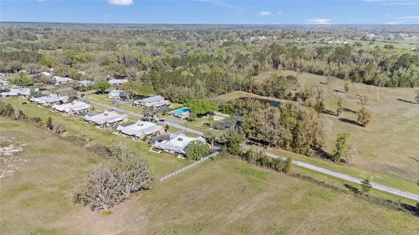 a view of a swimming pool with a yard and mountain view