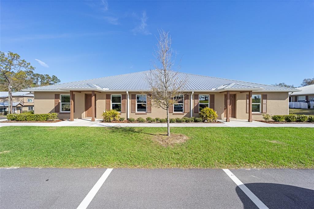4417 Northwest 74th Terrace Ocala, FL 34482 - Photo 6 of 77 a front view of a house with a garden