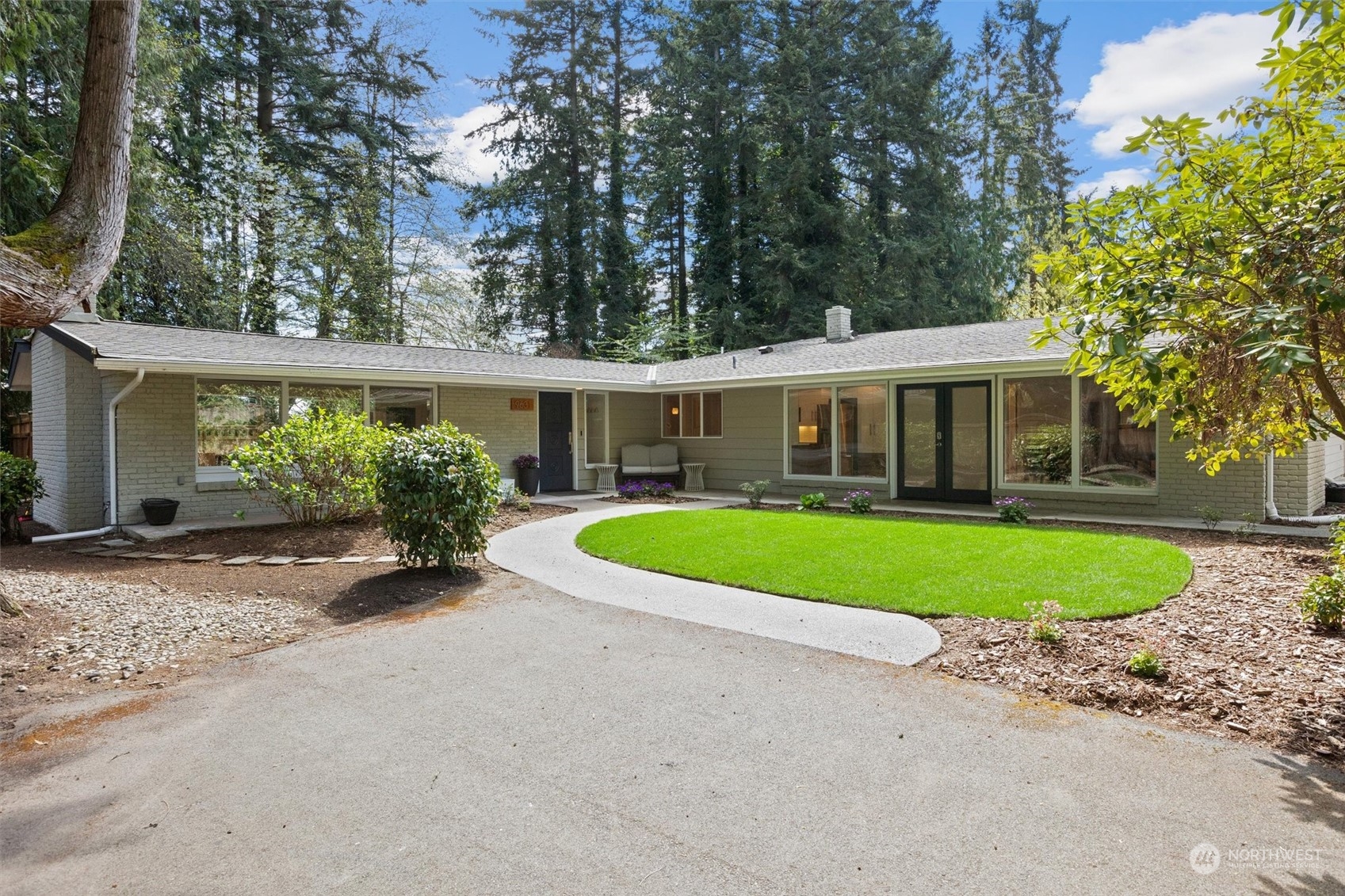 a view of a house with a swimming pool and a yard
