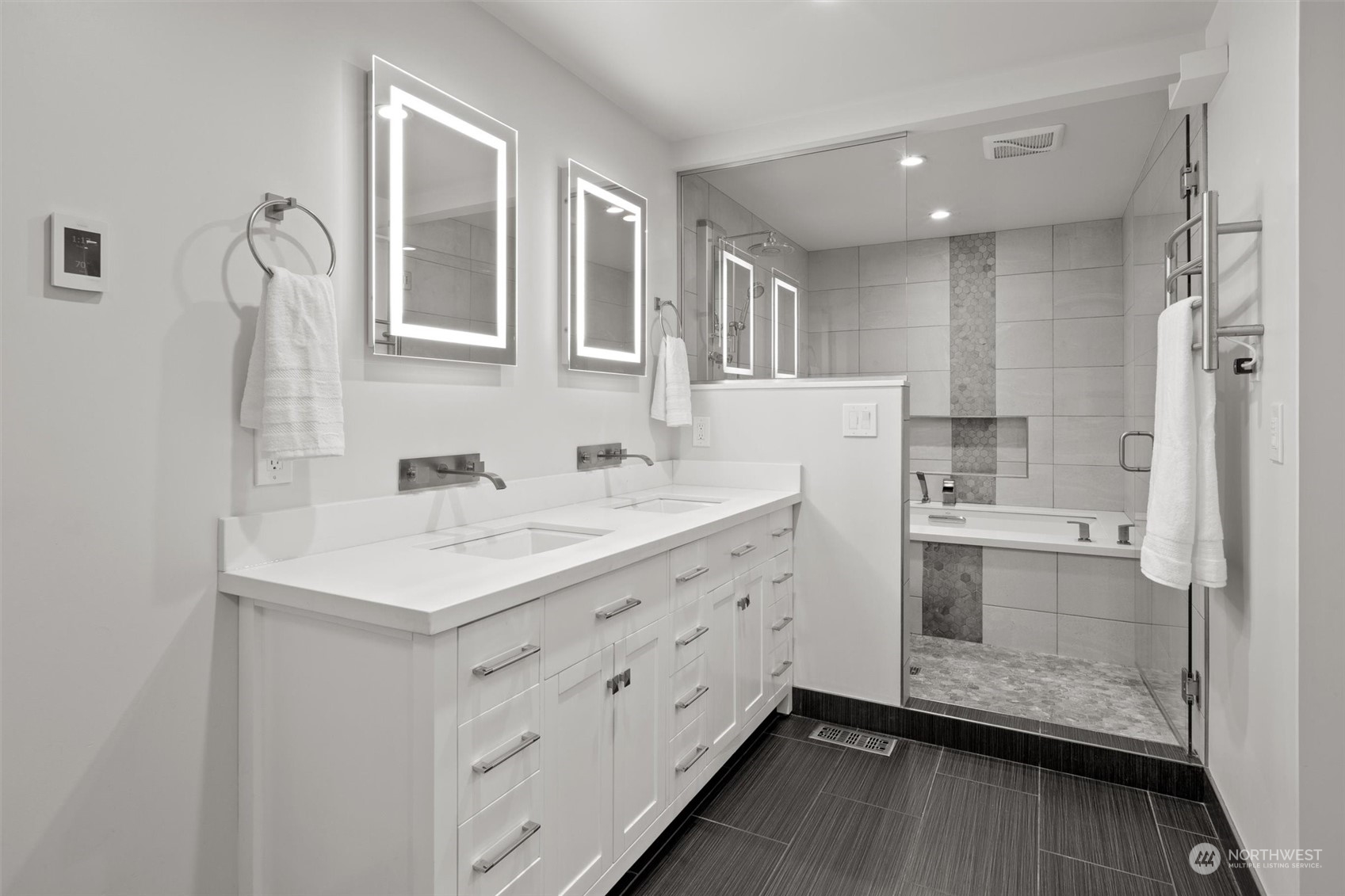 9631 Northeast 198th Street Bothell, WA 98011 - Photo 15 of 40 a bathroom with a sink a mirror and a shower