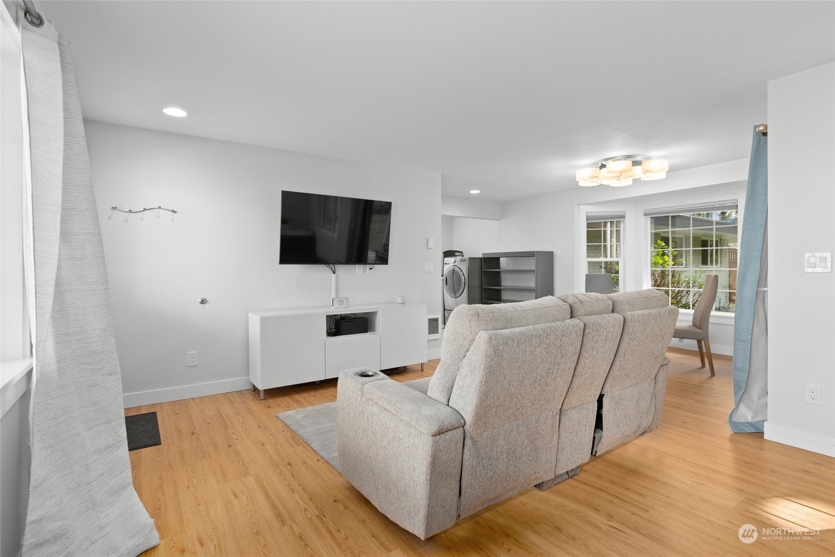 9631 Northeast 198th Street Bothell, WA 98011 - Photo 24 of 40 a living room with furniture and a flat screen tv