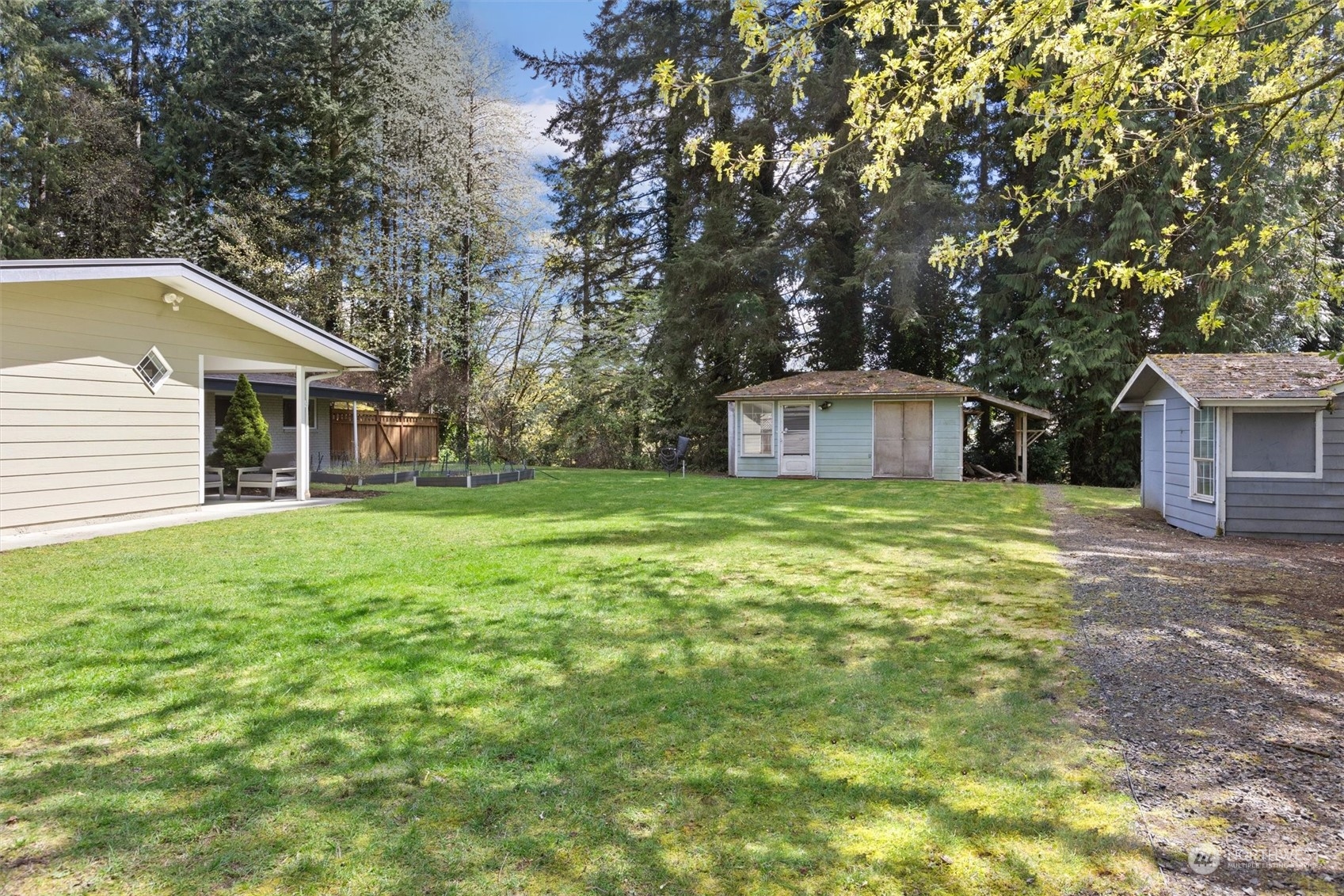 9631 Northeast 198th Street Bothell, WA 98011 - Photo 31 of 40 a white house with a small yard and large trees