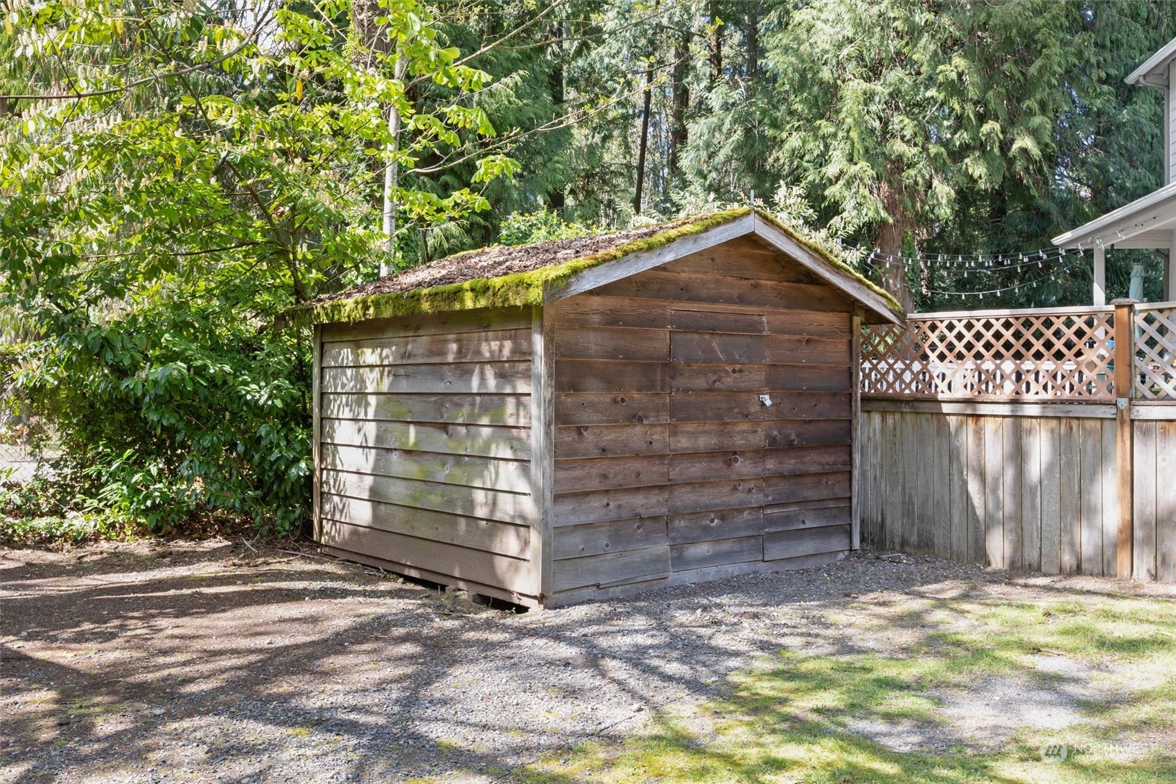 9631 Northeast 198th Street Bothell, WA 98011 - Photo 34 of 40 a wooden door in front of a house with a large tree