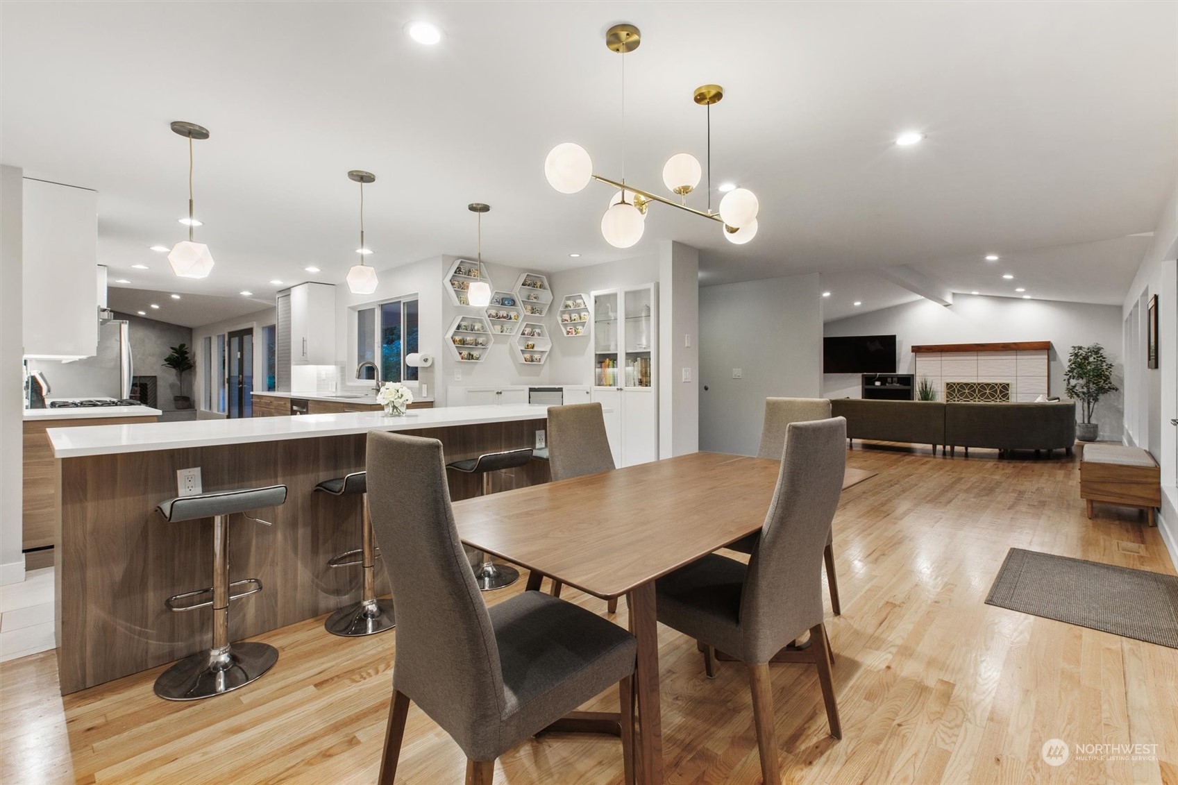 9631 Northeast 198th Street Bothell, WA 98011 - Photo 9 of 40 a kitchen with stainless steel appliances kitchen island granite countertop a table chairs and a refrigerator
