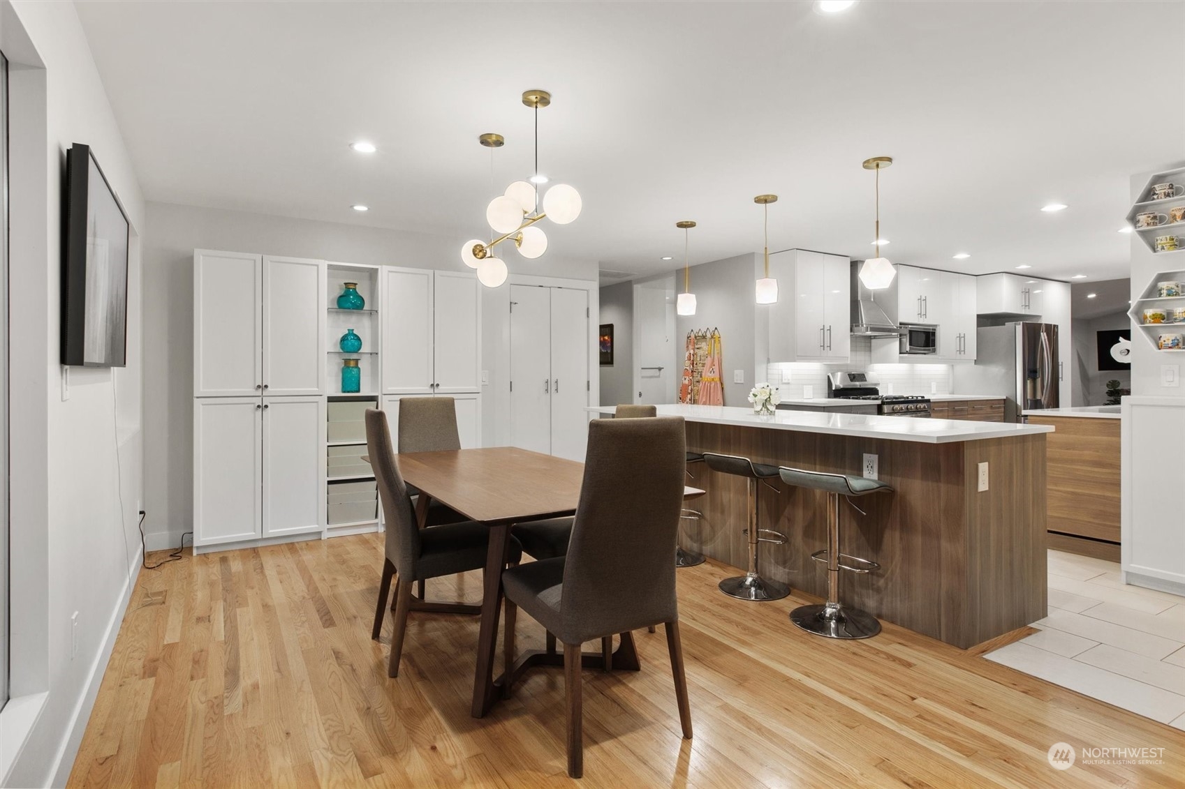 9631 Northeast 198th Street Bothell, WA 98011 - Photo 10 of 40 a dining hall with stainless steel appliances kitchen island granite countertop a dining table chairs and granite counter tops
