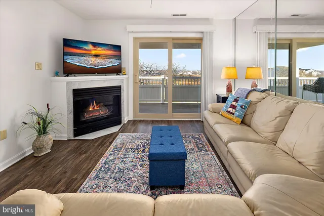 a living room with furniture fireplace and window