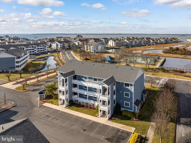 a view of a lake with houses in back